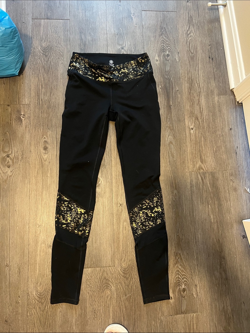GAIAM Black Leggings with Metallic Gold Print Waistband & Knee Panels